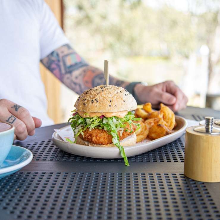 A man about to enjoy his burger