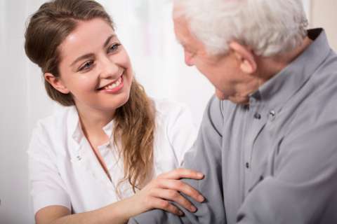 bigstock-Smiling-Nurse-Assisting-Senior-84769652